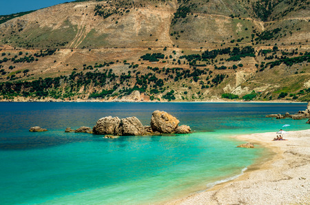 Vouti beach, Kefalonia island, Greece. People relaxing at the beach. The beach is surrounded by flowers.の写真素材