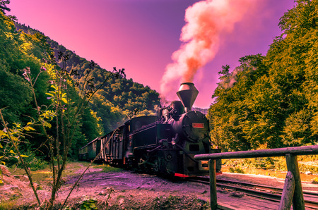 Old black steam powered railway train. Restored old vintage steam train built at Resita, Romania.の写真素材