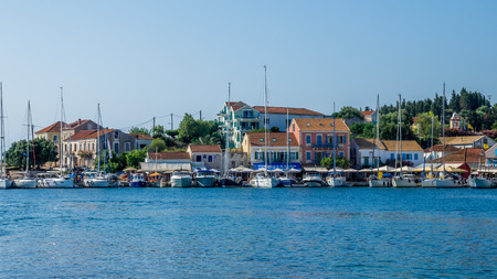 FISKARDO TOWN, KEFALONIA ISLAND, GREECE - JULY 12, 2015: Bay of Fiskardo with boats and yachts. Port of Fiskardo on Kefalonia island, Greece.のeditorial素材