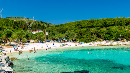 EMBLISI BEACH, KEFALONIA ISLAND, GREECE, JULY 12, 2015: People relaxing at the beach. Emblisi Beach, Kefalonia Island, Greeceのeditorial素材
