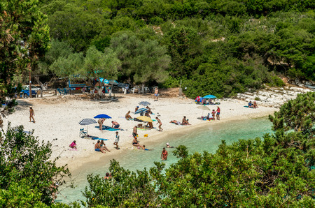 EMBLISI BEACH, KEFALONIA ISLAND, GREECE, JULY 12, 2015: People relaxing at the beach. Emblisi Beach, Kefalonia Island, Greeceのeditorial素材