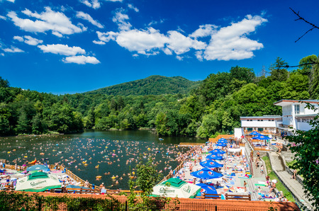 SOVATA, URSU LAKE, ROMANIA - AUGUST 8, 2015: People relaxing at the beach in Sovata, Transylvania, Romania.のeditorial素材