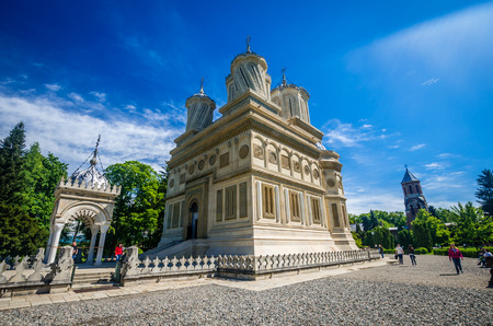 CURTEA DE ARGES MONASTERY - MAY 14. Unidentified tourists visiting Curtea de Arges Monastery. It is...