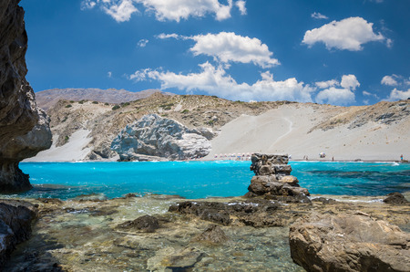 Agios Pavlos Beach in Crete island, Greece. Tourists relax and bath in crystal clear water of St. Paul Sandhill Beach.の写真素材