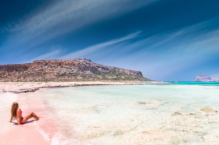 Balos lagoon on Crete island, Greece. A girl on a beach with pink sand.の写真素材