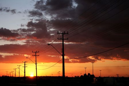 A beuatifull sunset over the road and the skyline in a big city