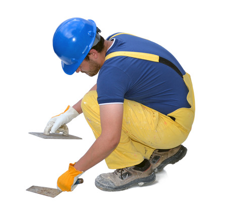 Construction worker bent down, isolated on white の写真素材