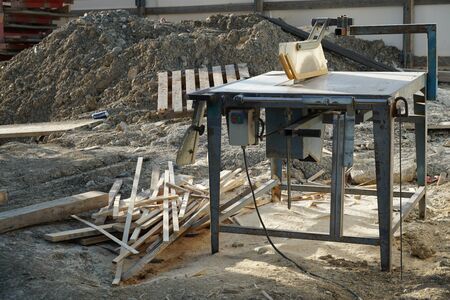 Detail of a buzz saw on a construction site. the indented blade under a plastic protective cover....