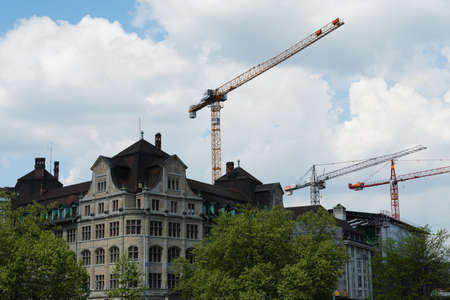Historical center, old city of Zurich wit three cranes on the background. They are symbol for reconstruction and renewal of historical buildingsのeditorial素材