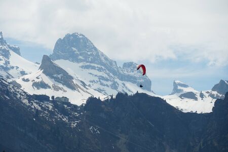 A lonely paraglider on the background of Alp mountains in Engelberg, Switzerland.