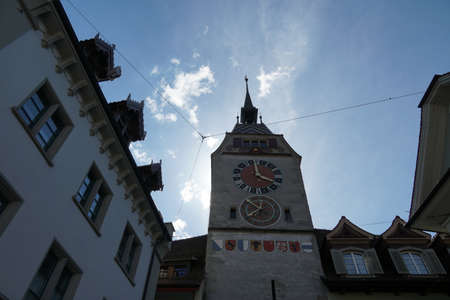 Zug / Switzerland 05 09 2020: Zug clock tower in the upper perspective in the context of the surrounding historical buildings and architecture.の写真素材