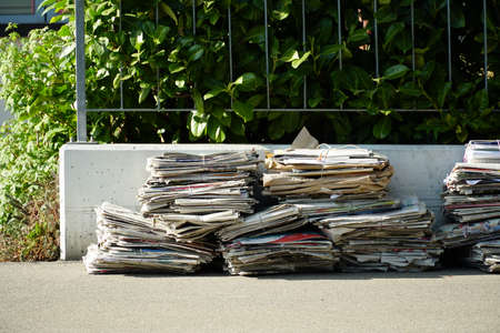 Waste separation in Switzerland. Old paper bundled into packets and put on the street to be...