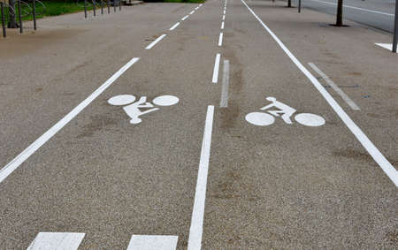 Bike lanes or cycle paths in opposite directions along the car road in the city of Belfort in...
