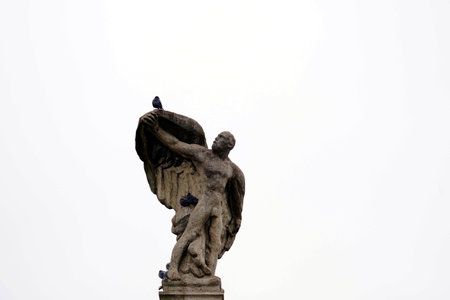 Constance, Germany - 11 28 2020: A statue of a man. It seems that he is looking at a raven who landed on his outstretched hand. Monument for Graf Zeppelin, pioneer in aviation, striving for progress.のeditorial素材