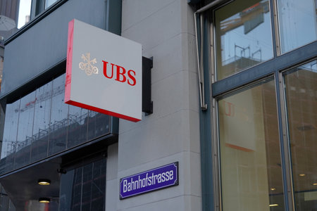 Zurich, Switzerland - 12 20 2020: Logo of a Swiss bank UBS in center of Zurich on Bahnhofstrasse, the most expensive street in the town, in red and white colors.のeditorial素材