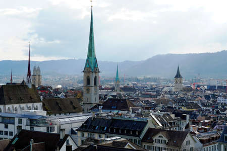Zurich, Switzerland - 03 12 2020: Panorama of Zurich historical center. Church towers are high above the rooftops, Predigerkirche, green tower in the foreground. Panoramic view in the old city.のeditorial素材