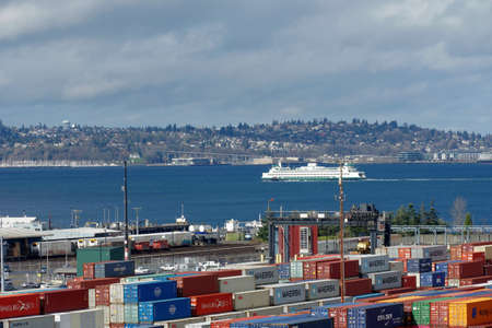 Passenger ferry is passing during the overcast day between Seattle and Bainbridge Island,...