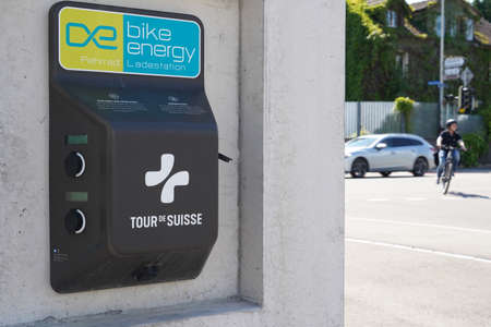 Kreuzungen, Switzerland 05 29 2021: Charging station for electric bicycles with cyclist and car...