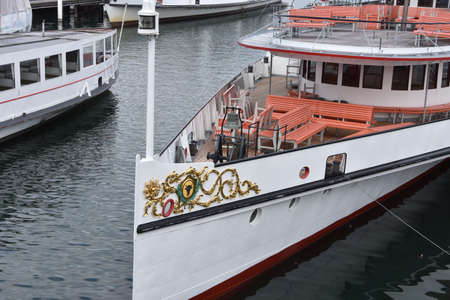 Empty moored tourist motor vessels in the harbor of city of Lucerne situated on Lake Lucerne. Ships are ready for embarkation and cruise trip around the lake.の写真素材