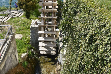 Front view on old wooden water-wheel mill beside house at the Rhine Falls in Schaffhausen.の写真素材