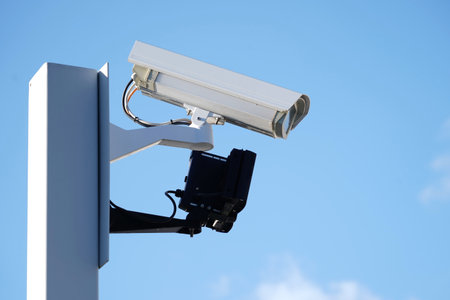 Industrial Security CCTV Camera installed on metal fence. The camera protects the industrial ground....