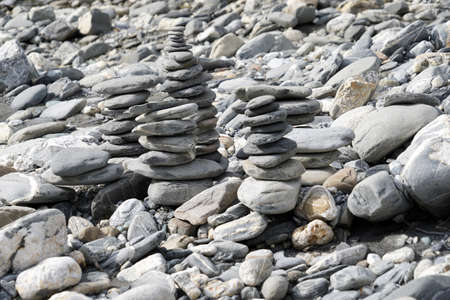 Stone towers or stone cairns. They are placed on the rocky river bank of Rhine in Switzerland.