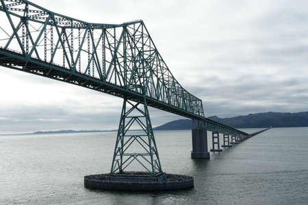 Astoria, USA 07 16 2021: AstoriaâMegler Bridge at Astoria over the Columbia River. View on a steel cantilever through truss bridge near the mouth of the river at the Pacific Ocean during overcast dayのeditorial素材
