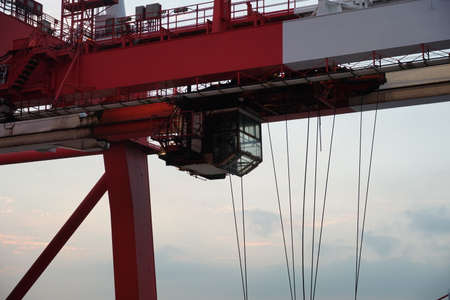 Empty control cabin of red white gantry cranes using for loading and discharging of containers from...