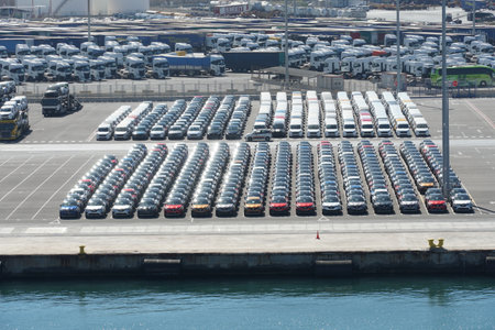 Valencia, Spain - 06 11 2022: Recently discharged new cars, lorries and busses are parking in port...