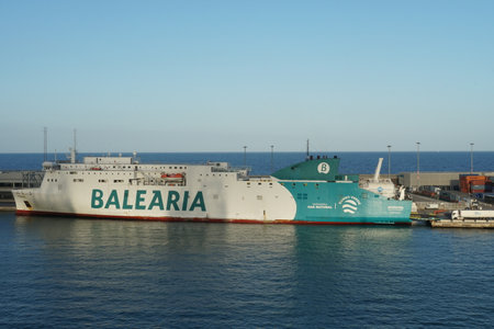 Barcelona, Spain - 06 09 2022: Ro-Ro, passenger ship operated by the Spanish company BALEARIA moored in Barcelona during loading cars and lories. Vessel operated with an LNG-powereのeditorial素材