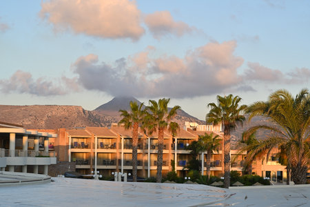 View from terrace of hotel on the palm trees and swimming pool in Holiday resort TUI Magic Life during sunrise. In the background is  building with rooms for tourist.のeditorial素材