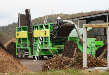 Side view on green starscreen machine producing biomass or reducing organic material so that it can...