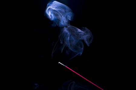 Incense  burning with beautiful blue smokeの写真素材