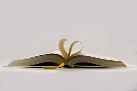 Heart shaped book  pages on white backgroundの写真素材