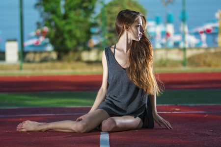 Ballerina resting on tennis courtの写真素材