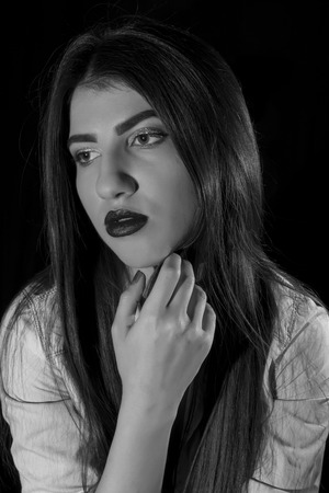 Young woman ,studio portrait on black backgroundの写真素材