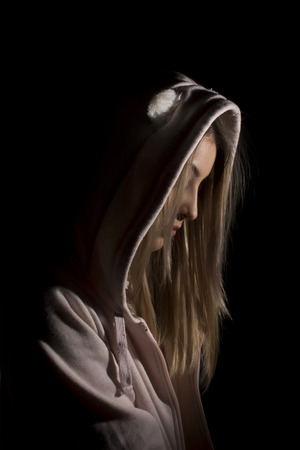 Blond woman wearing cardigan with hoodの写真素材