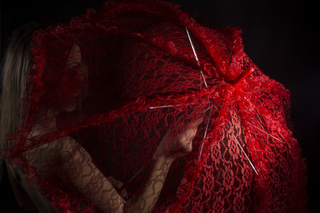 Naked woman with red umbrellaの写真素材