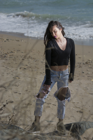 Young woman posing on Black Sea shore in a spring dayの写真素材