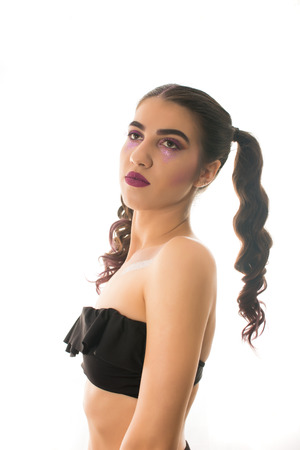 Young girl with two pony tails and artistic make up on  white  backgroundの写真素材