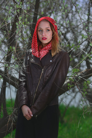 Portrait of a young girl with red scarf with white dotsの写真素材