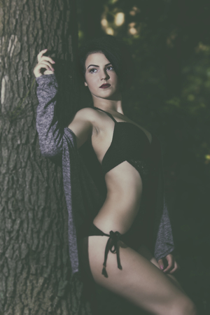 Pretty young girl posing outdoor in a forestの写真素材