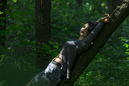 Pretty young girl posing outdoor in a forestの写真素材