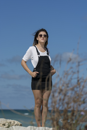 Beautiful young woman enjoying nature by the seaの写真素材