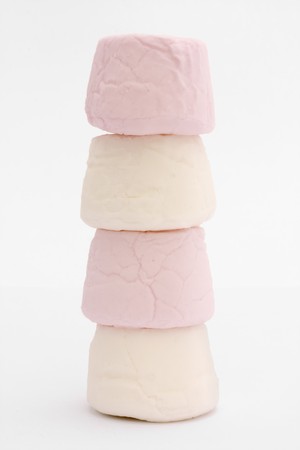 stack of pink and white marshmallows on a white backgroundの写真素材