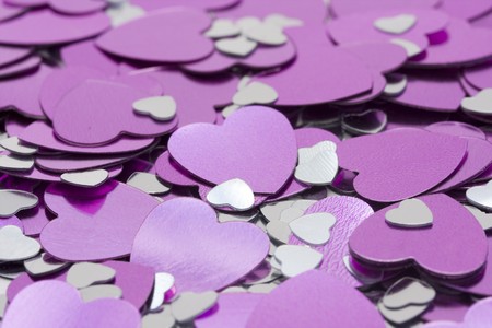 macro of metalic pink and silver heartsの写真素材
