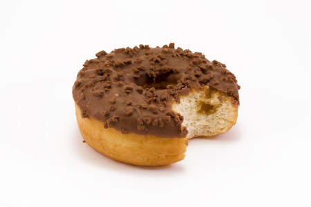 chocolate covered doughnut with a bite taken out over whiteの写真素材