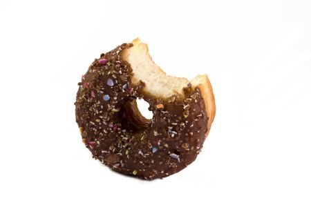chocolate covered doughnut with a bite taken out over whiteの写真素材