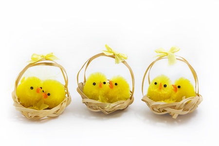 three baskets of easter chicks on a white background