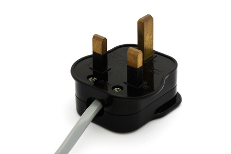 Black UK plug with a grey flex isolated over white